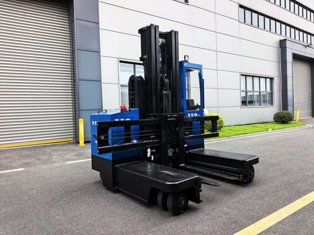 NEO FORKLIFT electric multi-directional forklift with tall mast in front of a factory building