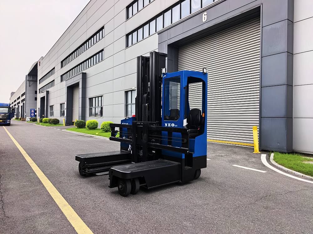 NEO FORKLIFT electric multi-directional forklift outside a warehouse loading dock